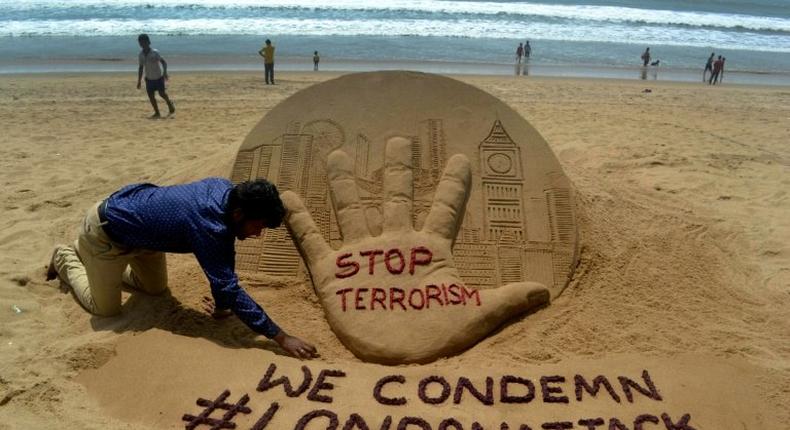 Indian sand artist Sudarsan Pattnaik creates a sculpture on Puri Beach on the Bay of Bengal the day after the London attack