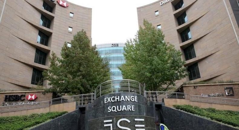 A worker sweeps in front of the Johannesburg Stock Exchange (JSE), in this picture taken March 23, 2016. Picture taken March 23, 2016. 