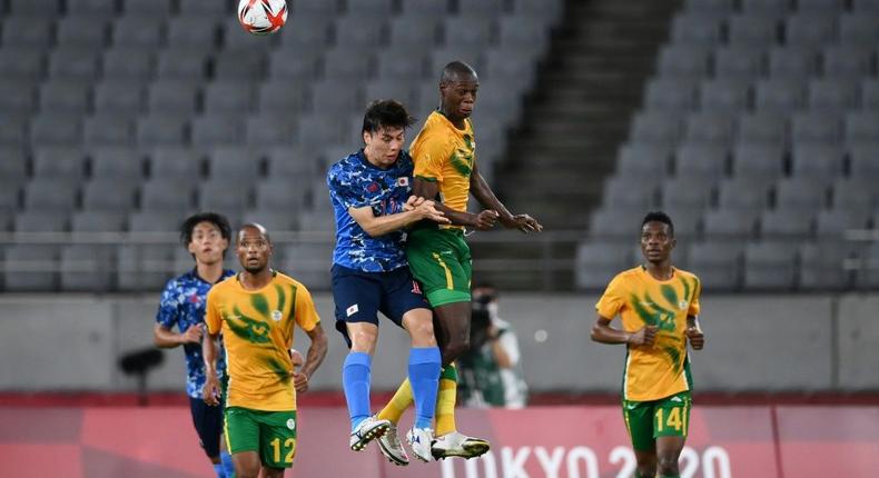High life: Japan midfielder Ao Tanaka jumps for a header with South Africa's Evidence Makgopa Creator: FRANCK FIFE