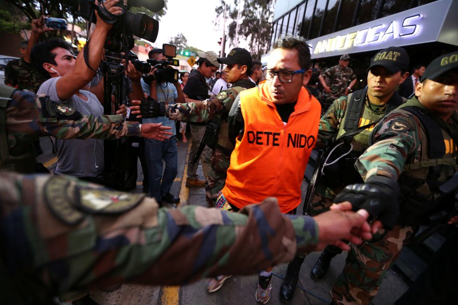 Peruvian police escort detainees after seizing more than 2 metric tons of cocaine hidden in packages of asparagus destined for Amsterdam, at police headquarters in Lima, Peru, January 12, 2017.