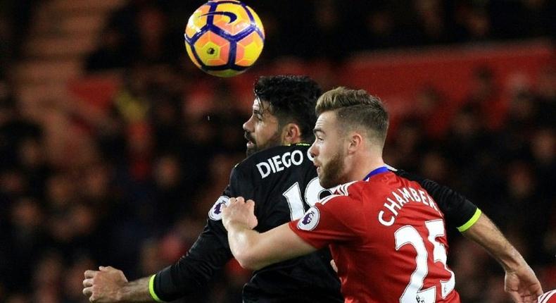 Chelsea's striker Diego Costa (L) vies in the air with Middlesbrough's defender Calum Chambers during the English Premier League football match November 20, 2016