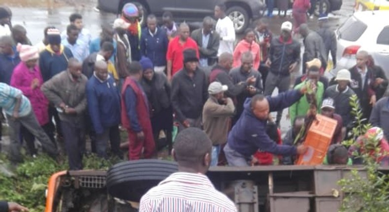 The matatu in the ditch with passengers stuck inside