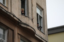 Policjanci zaglądający ze strażackiego podnośnika do mieszkania wynajętego przez działaczy Lotnej Brygady Opozycji