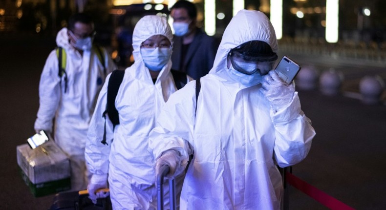 Many passengers wore hazmat suits as they arrived at Wuhan's Wuchang rail station to board some of the first trains to leave the Chinese city in more than two months