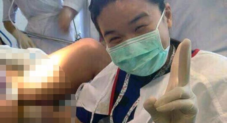 Selfie taken by doctor during surgery, with her hand inside the pregnant patients vagina