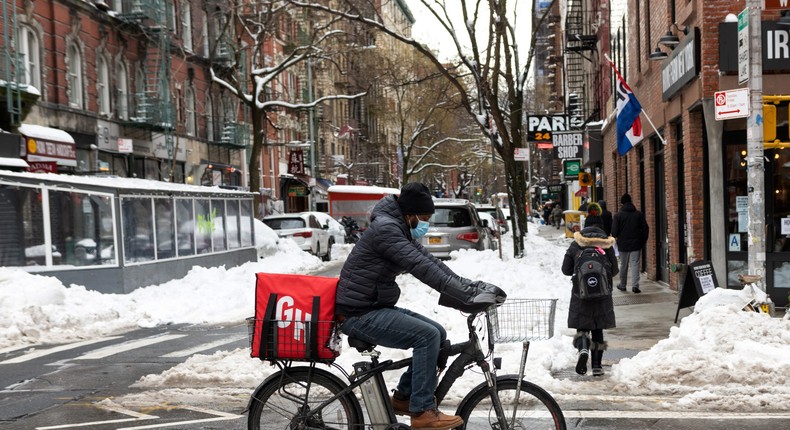 A Grubhub delivery driver rides through the snow.