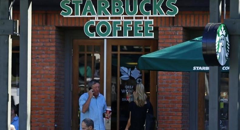 Customers visit a local Starbucks coffee shop in Del Mar, California November 13, 2013. REUTERS/Mike Blake