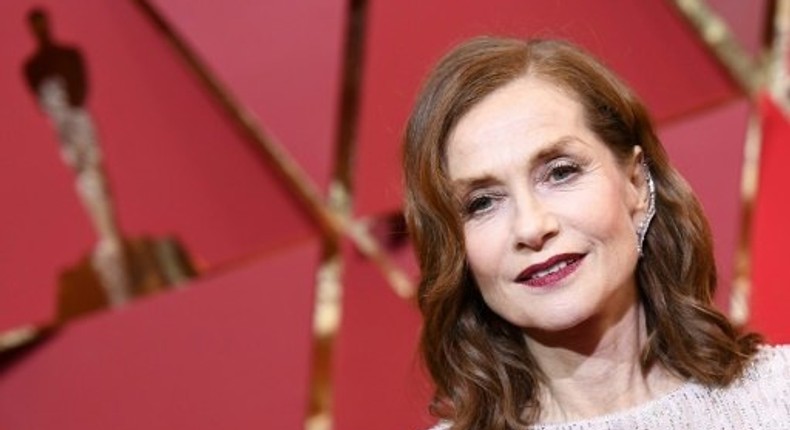 Nominee for best actress in Elle, Isabelle Huppert oozed glamour in her glittering long-sleeved, champagne floor-length Armani gown with a demure neckline