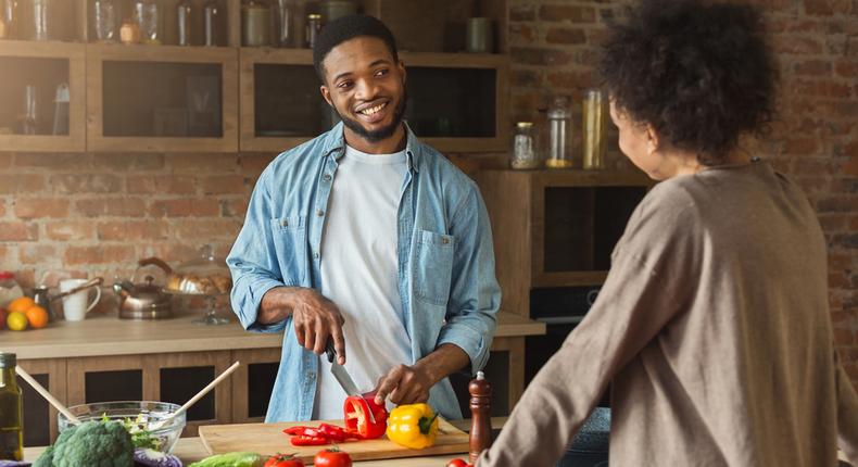 African American Couple Cooking in the Kitchen [Credit: Shuttrestock]