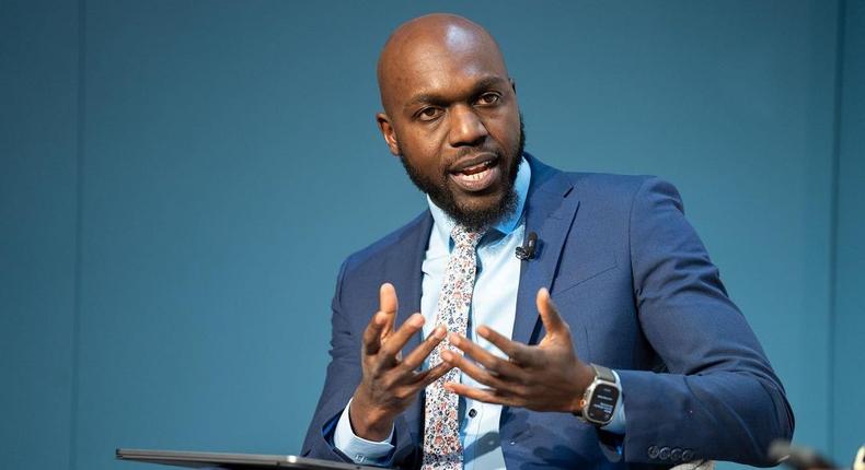 Larry Madowo moderating a panel discussion at the Word Economic Forum stage in January 2022