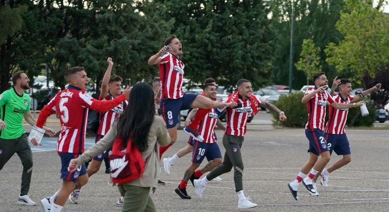 Atletico Madrid's players celebrate outside the Jose Zorilla Stadium after winning La Liga on Saturday. Creator: CESAR MANSO