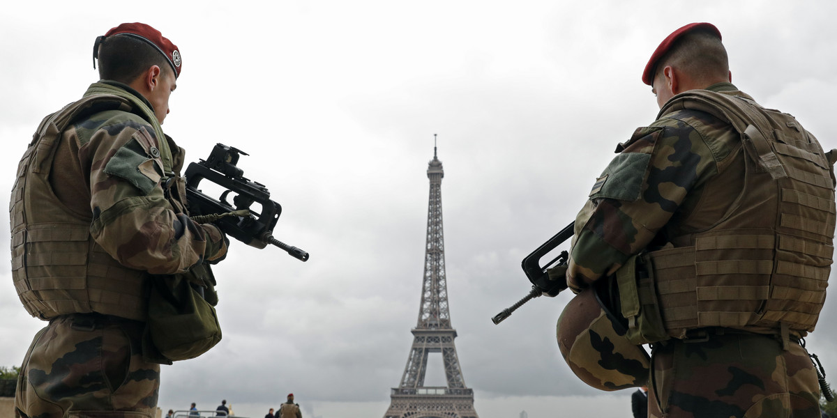 French army paratroopers patrol near the Eiffel Tower on March 30 as France has decided to deploy 1,600 additional police officers to bolster security at its borders and on public transport following the deadly blasts in Brussels.