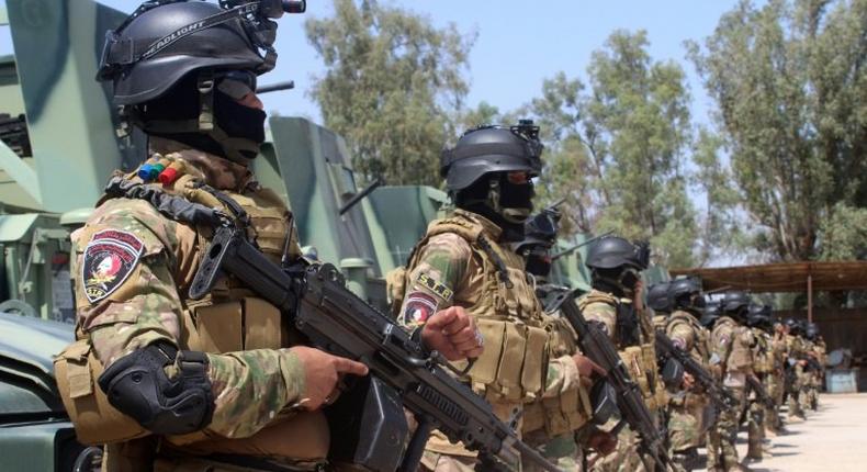 Iraqi police forces stand in front of armoured vehicles at the Habbaniyah base, east of Ramadi in Anbar province, in May 2016, ahead of a military operation against the Islamic State group in the Rutba area