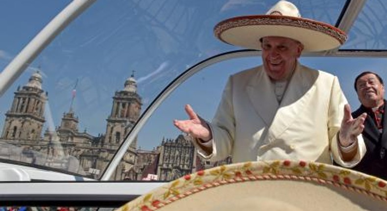 Pope Francis gestures while wearing a Mariachi hat given to him by someone in the crowd on Zocalo Square in Mexico City, February 13, 2016.