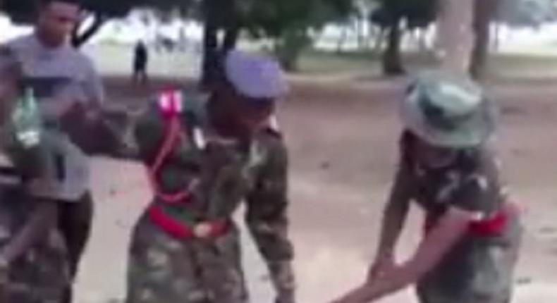 Cadet soldiers torturing a civilian