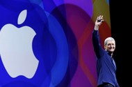 Apple CEO Tim Cook waves as he arrives on stage to deliver his keynote address at the Worldwide Developers Conference in San Francisco