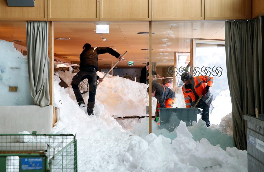 Workers shovel snow out of a restaurant after an avalanche at Santis-Schwaegalp mountain resort