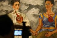Cameraman films Frida Kahlos painting at Mexico City's Bellas Artes museum