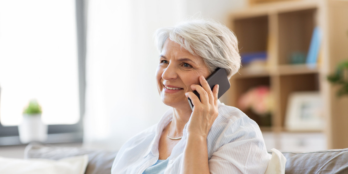 senior woman calling on smartphone at home