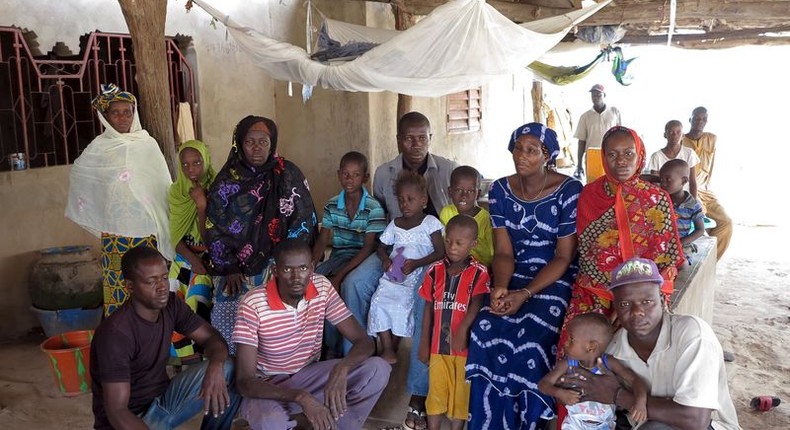 Nfamara Diawarra (C, in gray), 36, poses for a picture with his family in Segoucoura, Senegal, June 18, 2015.  REUTERS/Makini Brice