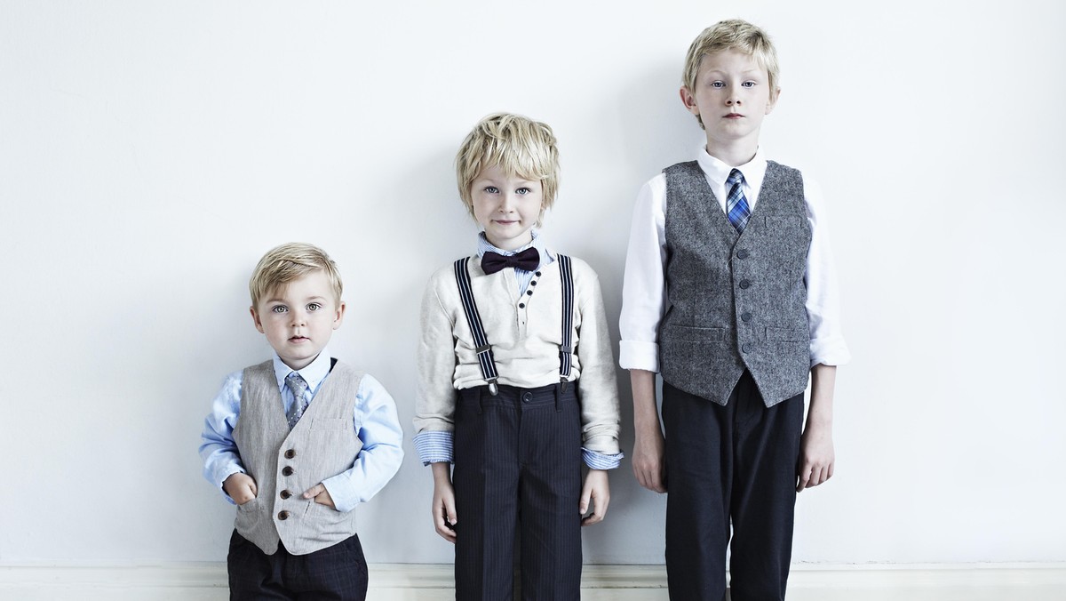 Brothers wearing suits indoors