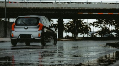 Silver car driving on a wet road [Image Credit: Eddy Silva Official]