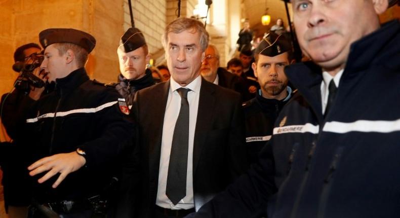 Gendarmes escort French former budget minister Jerome Cahuzac (C) as he leave the Paris courthouse following his tax fraud and money laundering trial's verdict on December 8, 2016