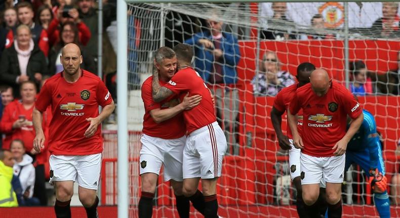 Manchester United '99 Legends celebrate a goal against Bayern Munich in a charity match