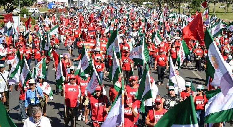 Members of Brazilian social movements march in Brasilia during a national strike against a government's Brazilian Social Welfare reform project on March 15, 2017