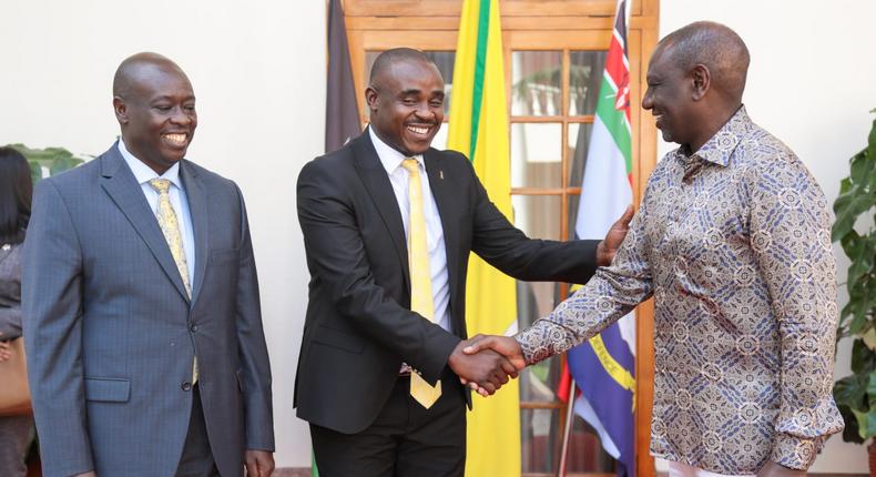 President William Ruto greets UDA Sec Gen Cleophas Malala as Deputy President Rigathi Gahchagua looks on at State House, Nairobi