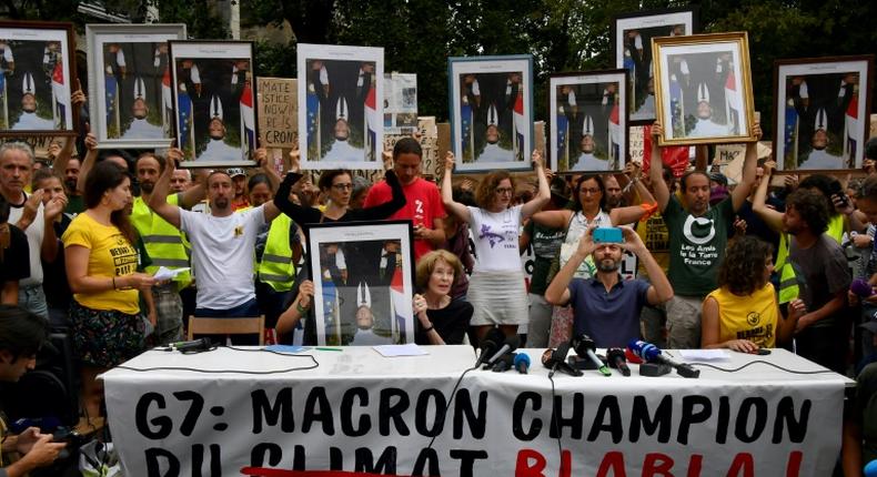 Demonstrators at the so-called portrait march were carrying official portraits of the 41-year-old French leader