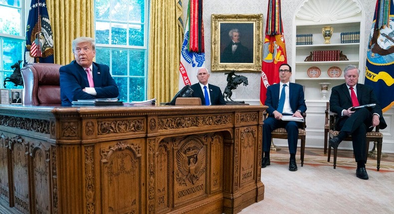 Then-President Donald Trump speaks during a meeting in the Oval Office with, from left, then-Vice President Mike Pence, then-Treasury Secretary Steven Mnuchin, and then-White House chief of staff Mark Meadows, on July 20, 2020.