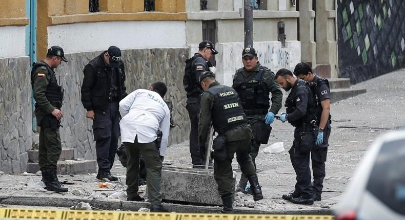 Colombian anti-explosives police inspect the site where a bomb exploded near the La Santamaria bullring in downtown Bogota, Colombia, on February 19, 2017