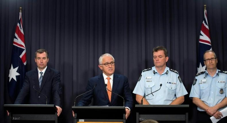 Prime Minister Malcolm Turnbull (2nd L)says the arrest of a man charged with helping the Islamic State group is a reminder that terrorism is an enduring threat