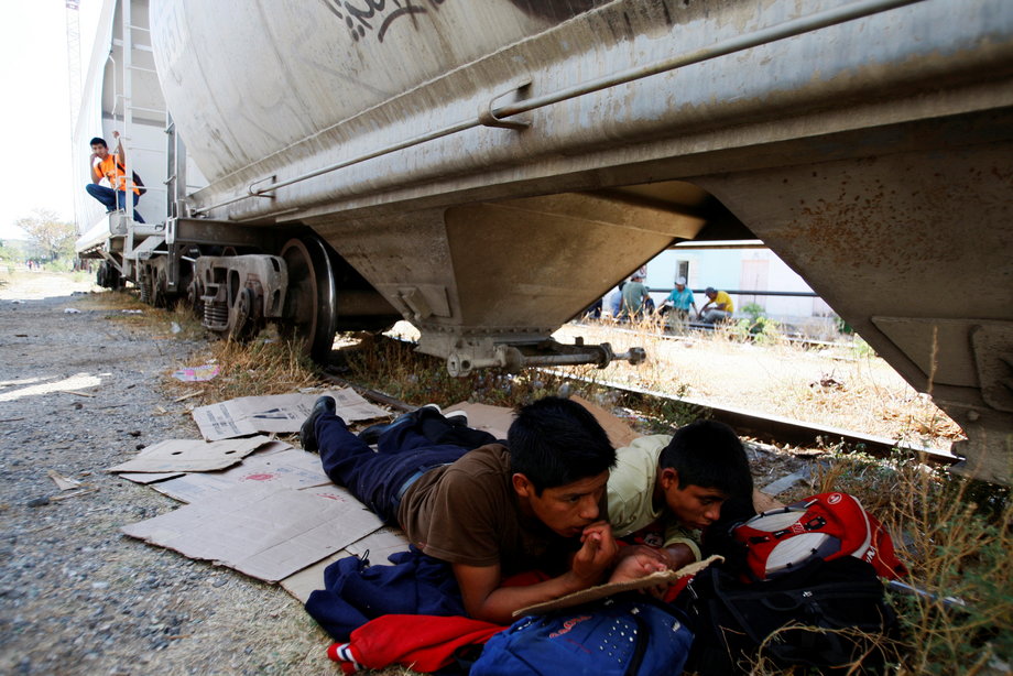 Central American migrants rest next to the train tracks while waiting for the freight train "La Bestia," or the Beast, to travel to the US border, at Arriaga in the state of Chiapas January 10, 2012.