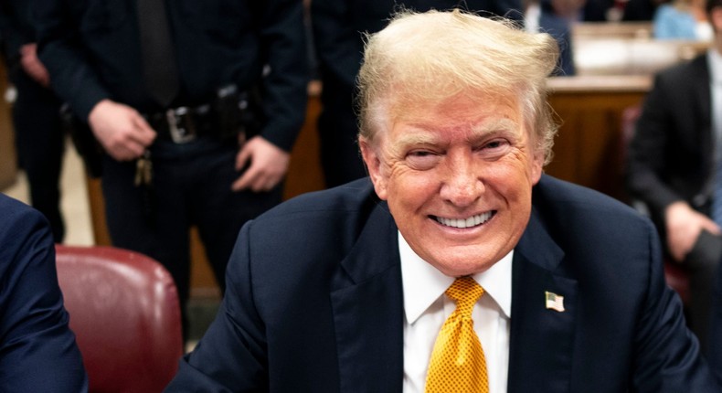 DDonald Trump smiles for pool photographers at his hush-money trial in Manhattan.Doug Mills/The New York Times via AP, Pool