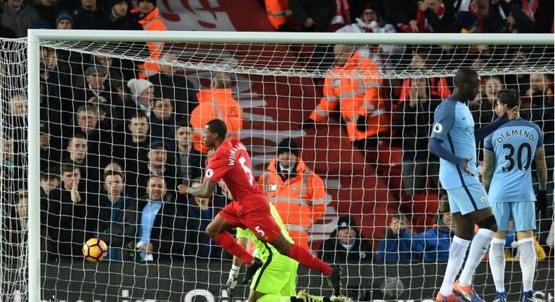 Liverpool's Dutch midfielder Georginio Wijnaldum (C) celebrates after scoring the opening goal of the English Premier League football match between Liverpool and Manchester City at Anfield in Liverpool, north west England on December 31, 2016