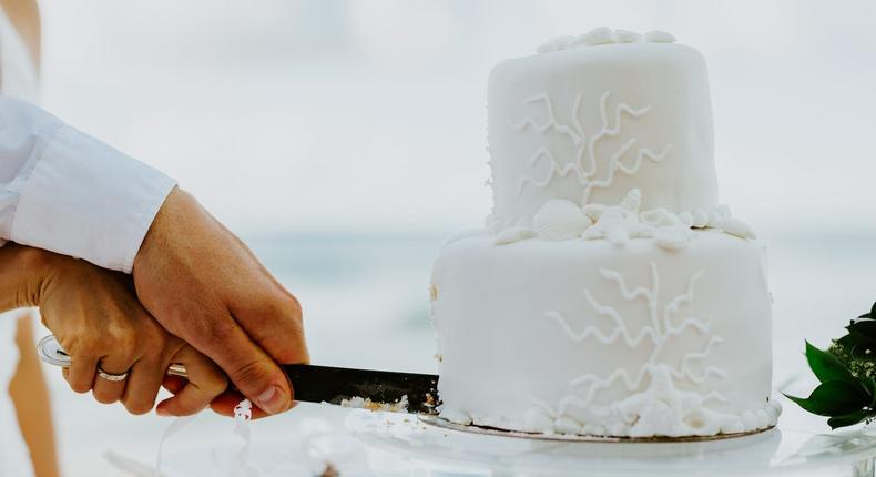 A couple cuts their wedding cake.
