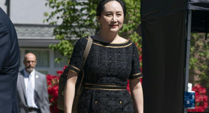 Meng Wanzhou, CFO of Huawei, walks down her driveway to her car as she departs her home for court on May 27, 2020 in Vancouver, Canada