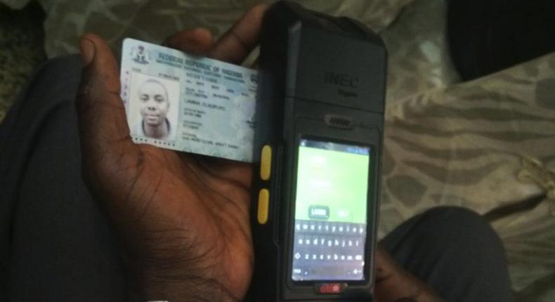 A Permanent Voter's Card being tested on a card reader meant for use in Nigeria's upcoming general elections.