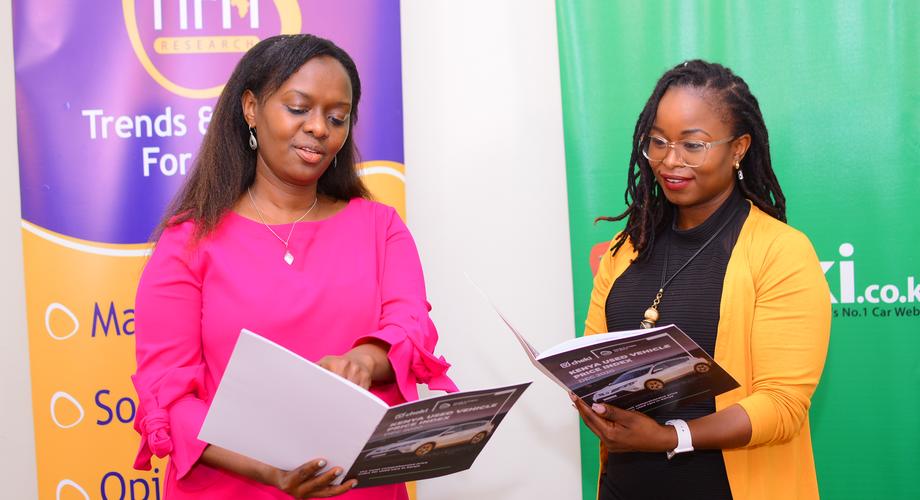 Trends and Insights Africa (TIFA) CEO Maggie Ireri with and Cheki Kenya CEO Resian Leteipan as they view the report for Kenya Used Vehicle Price Index