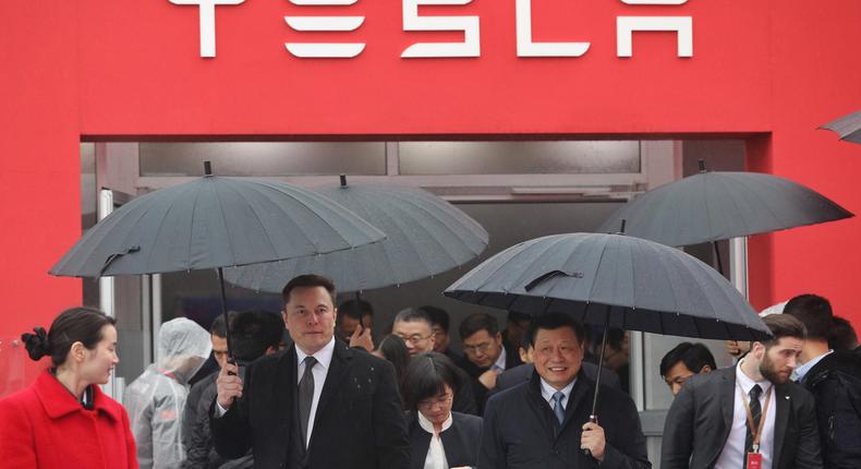 Tesla boss Elon Musk (L) walks with Shanghai Mayor Ying Yong during the ground-breaking ceremony for a Tesla factory in Shanghai on January 7, 2019.