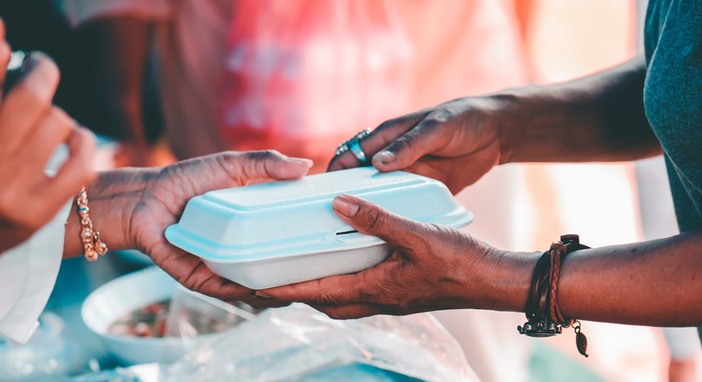 A stock photo of someone giving out food.kuarmungadd/Getty Images