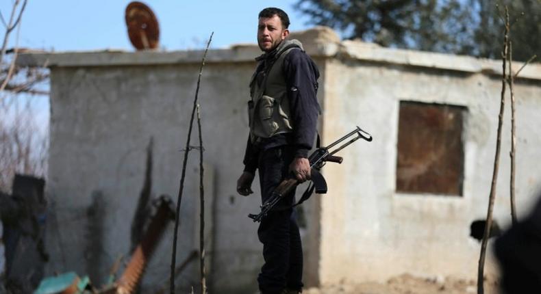 A fighter from Jaish al-Islam (Islam Army) rebel group stands guard in Bilaliyah, east Damascus, earlier this month