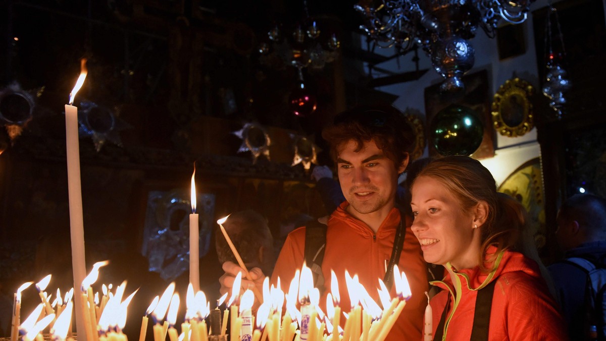 Christians Light Candles In Church Of Nativity In Bethlehem