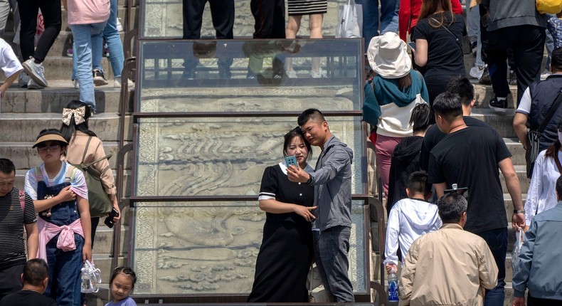 Visitors pose for a selfie at the Temple of Heaven on the last day of the May Day holiday period in Beijing, Wednesday, May 3, 2023Mark Schiefelbein/AP Photo