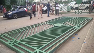 The National Assembly gate pulled down by protesters. [Punch]