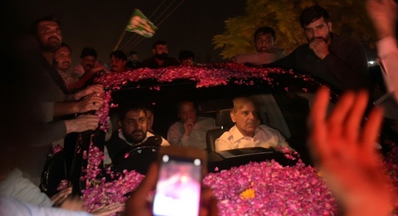 Former Pakistani prime minister Nawaz Sharif was driven away in an SUV as it was pelted with rose petals in celebration, with younger brother Shahbaz Sharif in the front seat of the vehicle