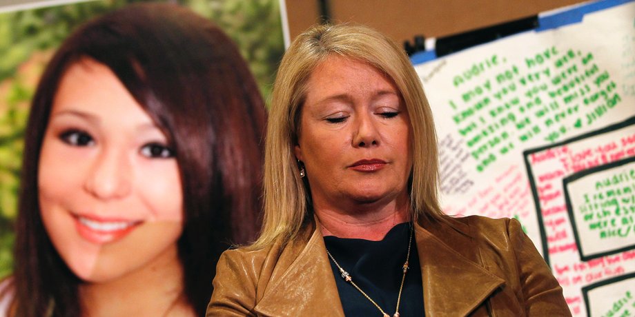 Sheila Pott pauses in front of a portrait of her teenage daughter, Audrie Pott, at a news conference in San Jose, California April 15, 2013.