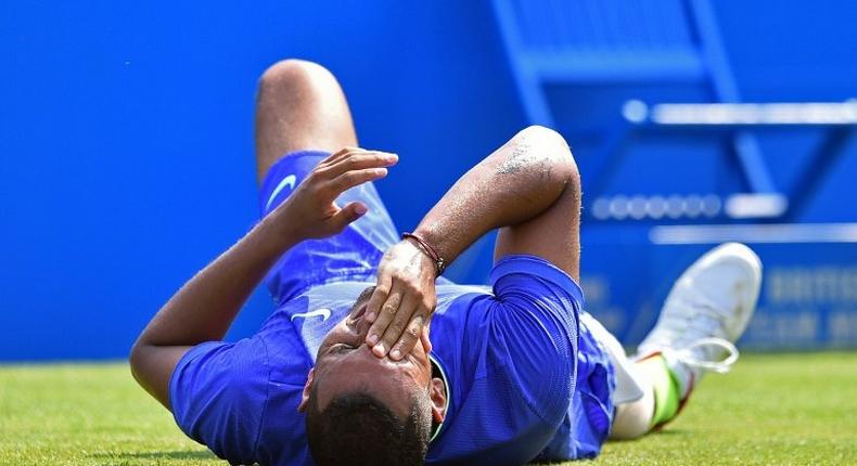 Australia's Nick Kyrgios reacts after slipping against Donald Young of the US in their men's singles first round match at Queen's Club in west London on June 19, 2017